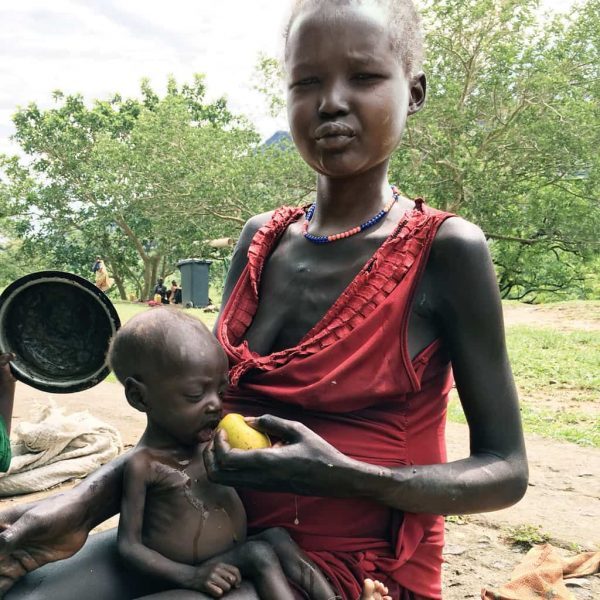 A malnourished mother and child receive help at a feeding station in South Sudan.