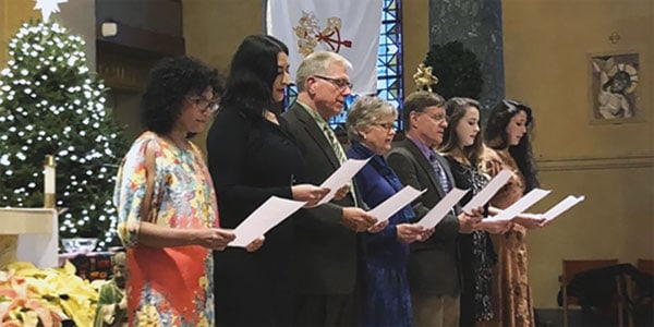 After World Mission Sunday Mass at St. Ferdinand Church, pastor Father Jason Torba and Cardinal Blase Cupich greet the congregation, including all those who do mission in Chicago. (Julie Jaidinger, Chicago Catholic/U.S.)