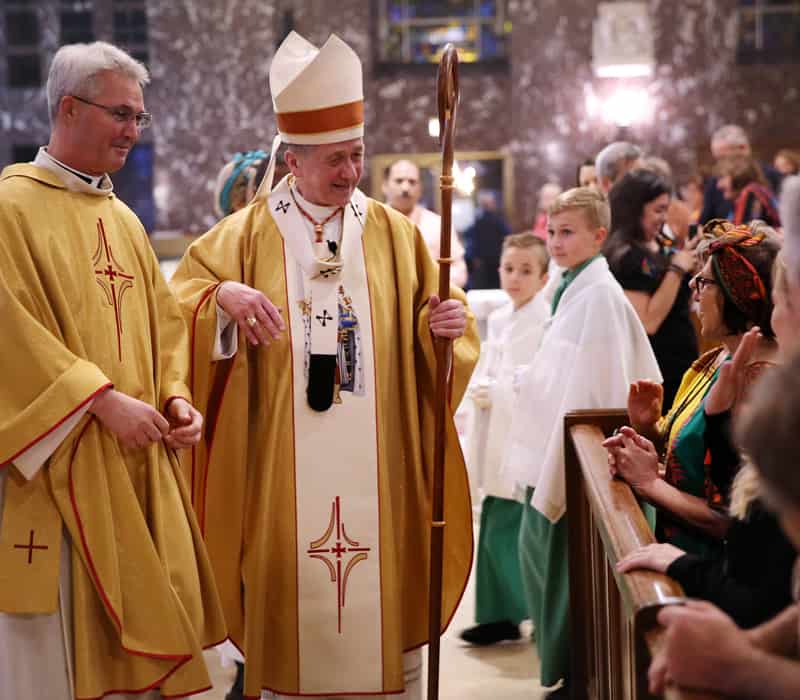 Chicago.Mission.05 After World Mission Sunday Mass at St. Ferdinand Church, pastor Father Jason Torba and Cardinal Blase Cupich greet the congregation, including all those who do mission in Chicago. (Julie Jaidinger, Chicago Catholic/U.S.)
