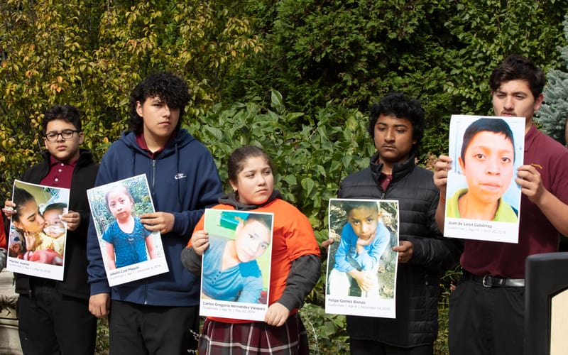 Young people exemplify mission in Chicago by participating in a prayer vigil calling for humane treatment for immigrant children such as those in the pictures they are holding, who died after being detained at the U.S. border. (Octavio Duran/U.S.)