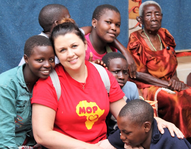 One of the faces of Chicago in mission is Marta Robak, coordinator of volunteers from St. Ferdinand parish who serve with the Missionaries of the Poor, a religious community of brothers who minister to the most vulnerable people. Robak finds joy surrounded by residents of MOP-run Good Shepherd Orphanage Center for girls and elderly women in Uganda. (Courtesy of Marta Robak/Uganda)