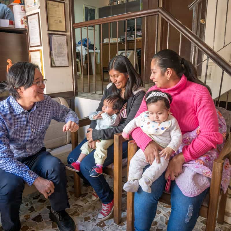 Solidarity bridge: Maryknoll Father Dae Kim welcomes Roxana Mamani (left) and her baby Ailee, and Ariane Castro and her daughter Mariana at the office of Puente de Solidaridad. (Nile Sprague/Bolivia)