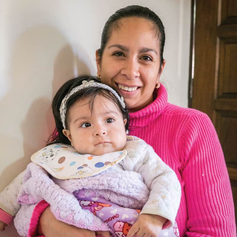 Solidarity bridge: Ariane Castro holds her daughter Mariana, who had successful heart surgery at a hospital in Cochabamba, as did her sister Valeria, thanks to Puente de Solidaridad. (Nile Sprague/Bolivia)
