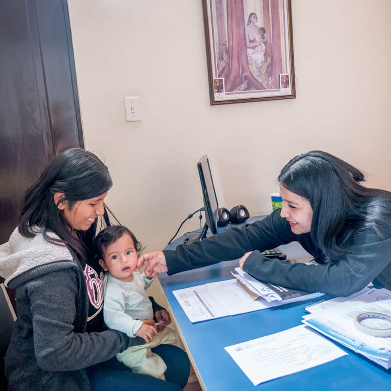 Solidarity bridge: Roxana Mamani (left) and her daughter Ailee visit Marizol Mamani, the social worker of Puente de Solidaridad. (Nile Sprague/Bolivia)