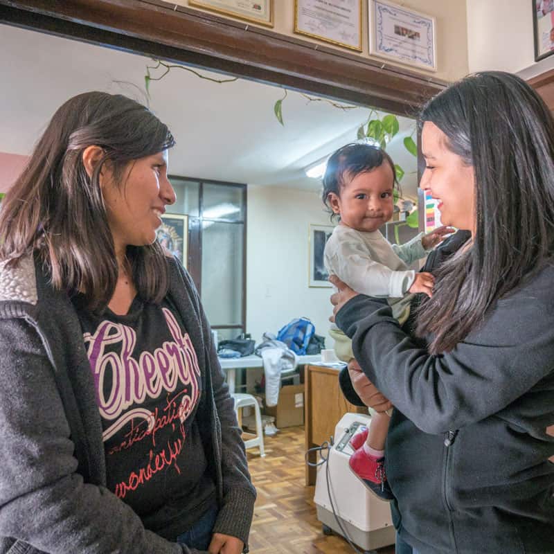 Solidarity bridge: Roxana Mamani (left) shares her story with Marizol Mamani (no relation), the social worker of Puente de Solidaridad holding Roxana’s baby Ailee, who was diagnosed with a congenital heart disease. (Nile Sprague/Bolivia)