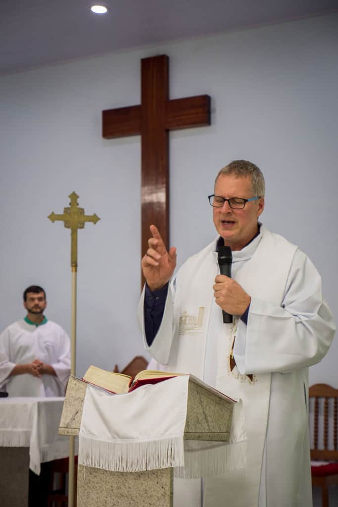 ather Dennis Moorman, here giving a homily at Mass on the feast of St. Joseph, patron of the parish in Perus, State of São Paulo, Brazil, where he serves, helps people cope with the trauma of COVID-19.. (Nile Sprague/Brazil)