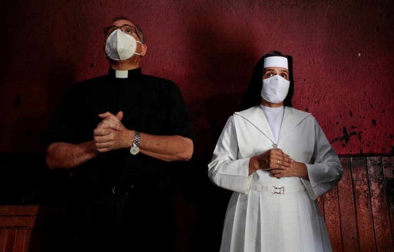 A priest and nun pray in the Blood of Christ Chapel at the Metropolitan Cathedral in Managua, Nicaragua, July 31, 2020, after was it destroyed in an arson attack. (CNS photo/Oswaldo Rivas, Reuters)