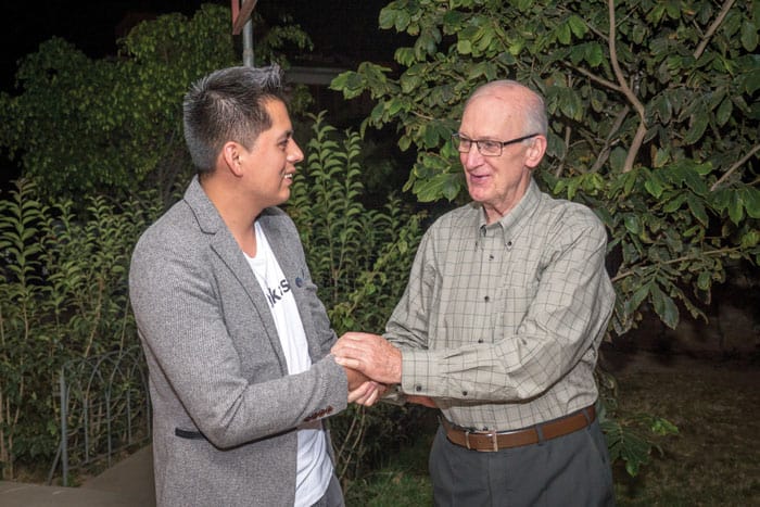 Father Chapin shakes hands with Ronald Albarez, a young parishioner and psychologist, who is helping other parishioners deal with COVID-19. (Nile Sprague/Bolivia)