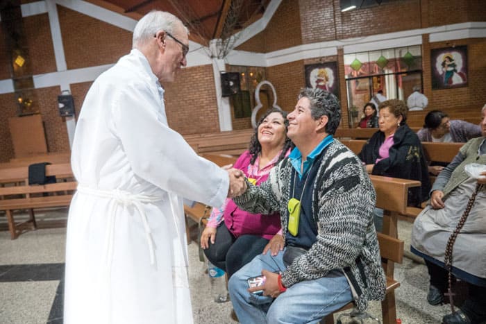 Father Chapin greets Bolivian parishioners in a photo taken before COVID-19.