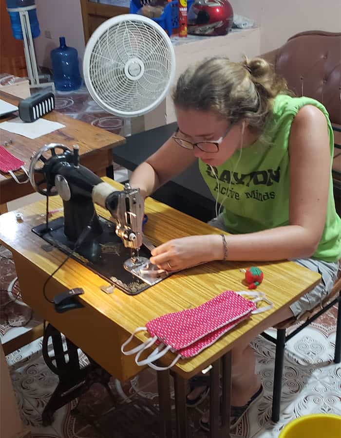 Jillian Foster, newest Maryknoll lay missioner in Haiti, painstakingly joins in mask making shortly after her arrival coincided with the arrival of COVID-19. (Courtesy of Abby Belt/Haiti)