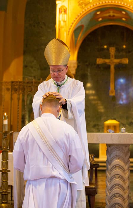 Bishop Edmund J. Whalen at the Laying on of Hands during the latest ordination to the Maryknoll missionary priesthood. (Octavio Duran/U.S.)