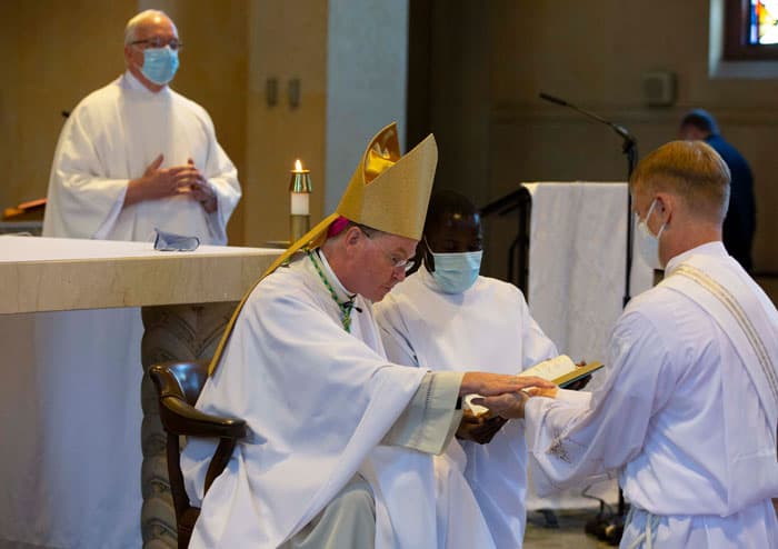 web-img_1248 Bishop Edmund J. Whalen anoints McPhee's hands with oil at the young man's ordination to the Maryknoll missionary priesthood. (Octavio Duran/U.S.)