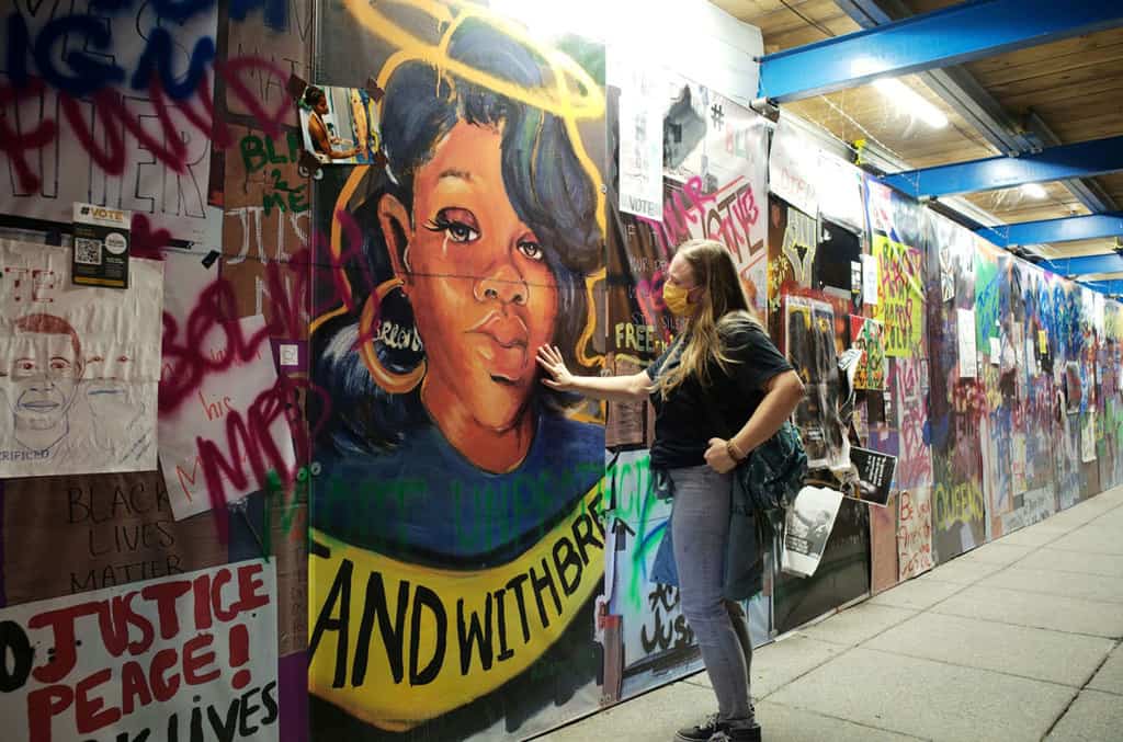 A woman in Washington touches a Breonna Taylor mural at Black Lives Matter Plaza on Sept. 24, 2020. (CNS/Cheriss May, Reuters)