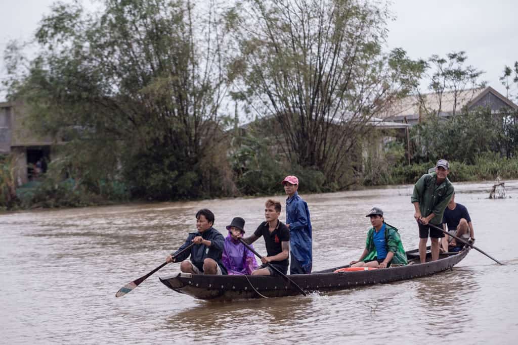 Local residents row a boat to a pickup point for delivering aid packages to residents affected by flooding in Thua Thien Hue province, Vietnam, Oct. 20, 2020. Two dioceses in central Vietnam hit by some of the worst floods in the country’s history are struggling to provide emergency aid for hundreds of thousands of victims. (CNS/Yen Duong, International Federation of the Red Cross handout via Reuters)