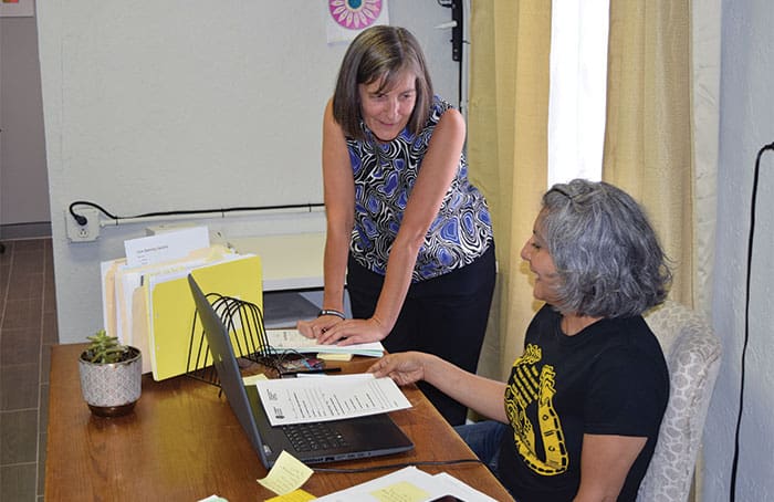 42-46-Undocumented-women-1 Maryknoll Lay Missioner Heidi Cerneka (left), attorney, consults with paralegal Connie Lara at Las Americas Immigrant Advocacy Center in El Paso, Texas, where the pair offers legal aid to migrants on the U.S.-Mexico border. (Meinrad Scherer-Emunds/U.S.)