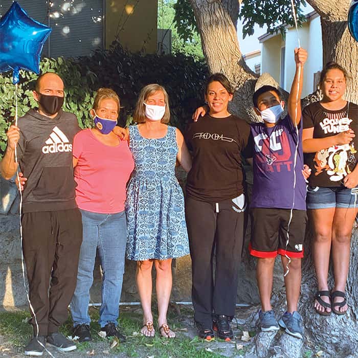 Back home after winning her case before an immigration judge to remain in the United States, Elizabeth (third from right) rejoices with her family and Maryknoll Lay Missioner Heidi Cerneka (print dress). (Coralis Salvador/U.S.)