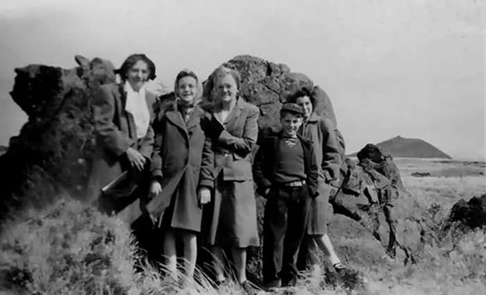 The Hannans: (r. to l.) Mari, Larry, their mom and Helen pose with a friend before the family left Tule Lake Segregation Center when their dad finished his work there in 1946. (Courtesy of Helen Parra)