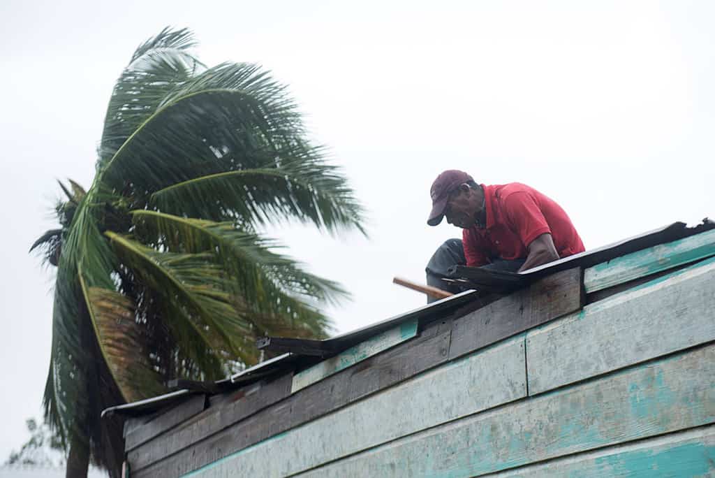 A man repairs the roof of his house as Hurricane Iota approaches Puerto Cabezas, Nicaragua, Nov. 16, 2020. Iota was the second Category 4 hurricane to hit the area within two weeks. (CNS/Wilmer Lopez, Reuters)