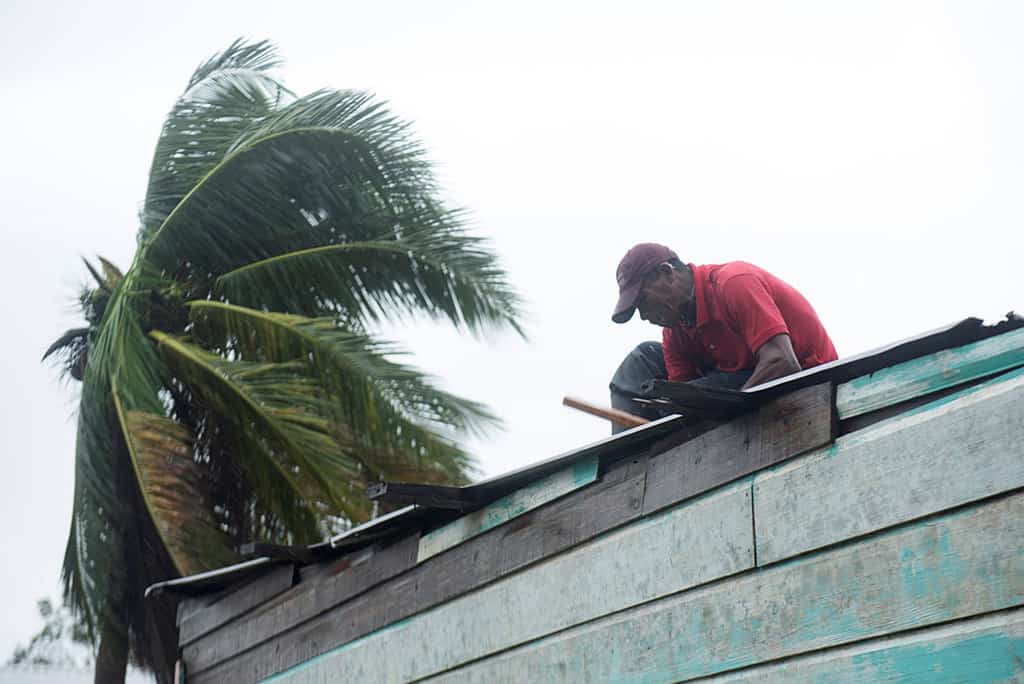 web-IOTA-CENTRAL-AMERICA-1009471 A man repairs the roof of his house as Hurricane Iota approaches Puerto Cabezas, Nicaragua, Nov. 16, 2020. Iota was the second Category 4 hurricane to hit the area within two weeks. (CNS/Wilmer Lopez, Reuters)