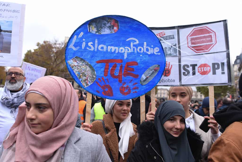 web-PEW-GOVERNMENT-RESTRICTIONS-RELIGION-1009015 People in Paris march against islamophobia Nov. 10, 2020, two weeks after an attack against a mosque in Bayonne and a rise in what activists allege is anti-Islam scaremongering and hostility among French leaders. The placard reads "Islamophobia Kills." (CNS/Mehdi Chebil, Hans Lucas via Reuters)