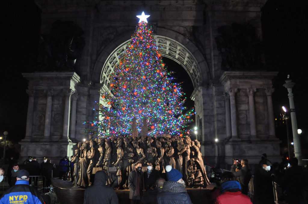 "Angels Unawares," a replica of the artwork that sits in St. Peter's Square at the Vatican, is unveiled Dec. 8, 2020, in front of the public Christmas tree put up by the Diocese of Brooklyn, N.Y., at Grand Army Plaza. (CNS/Ed Wilkinson, The Tablet)