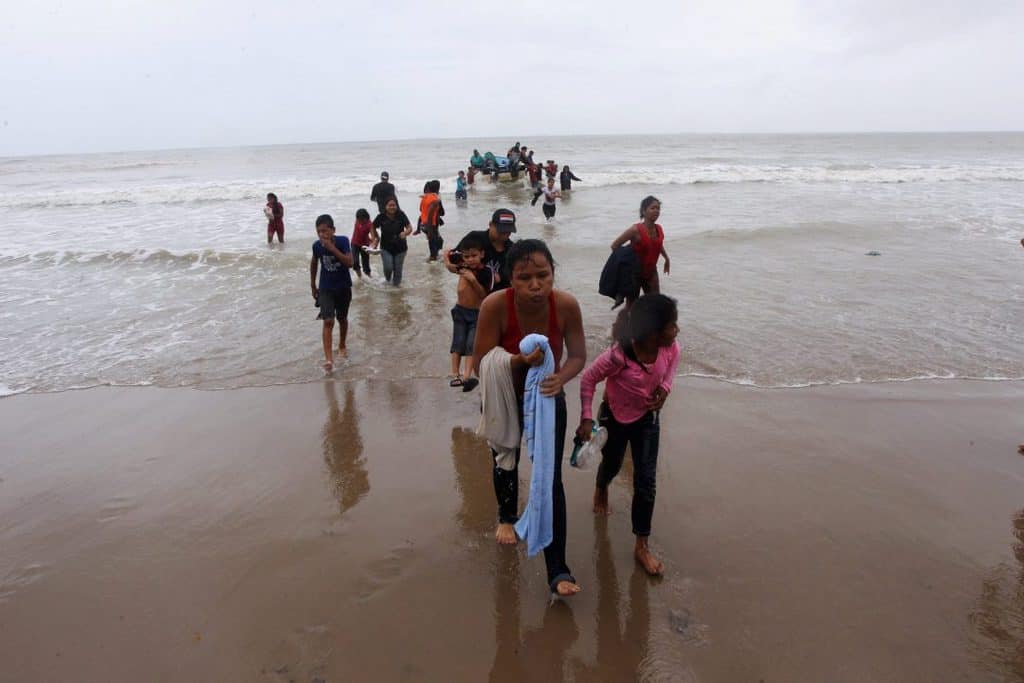 Venezuelan migrants arrive on shore at Los Iros Beach after their return to the island in Erin, Trinidad and Tobago, Nov. 24, 2020. After a different boat carrying refugees was allegedly denied entry into Trinidad and Tobago and subsequently shipwrecked, Venezuelan bishops said the treatment of migrants fleeing the country constitutes serious human rights violations. (CNS photo/Lincoln Holder, Newsday handout via Reuters)