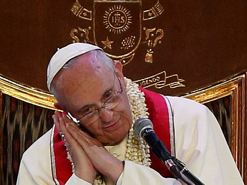 Pope Francis shows the sleeping posture of a statue of St. Joseph he keeps on his desk while giving a talk during a meeting with families in Manila, Philippines, in this Jan. 16, 2015, file photo. In a Dec. 8 apostolic letter, Pope Francis proclaimed a yearlong celebration dedicated to St. Joseph, foster father of Jesus. (CNS/Paul Haring)