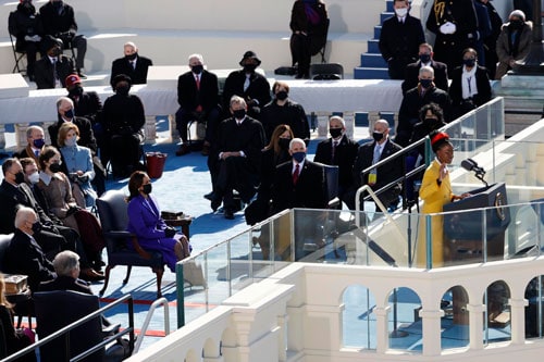 Amanda Gorman recites a poem at the U.S. Capitol Jan. 20, 2021, during the inauguration of Joe Biden as the 46th president of the United States. She is a parishioner at St. Brigid Catholic Church in Los Angeles. (CNS photo/Brendan McDermid, Reuters)