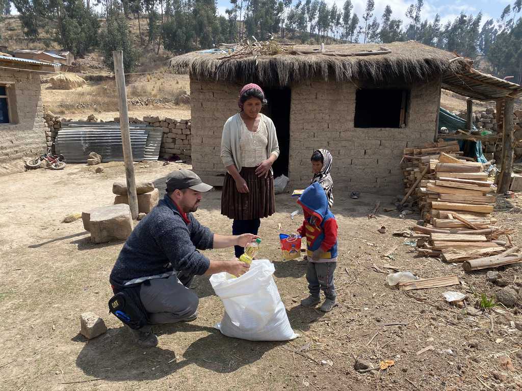 Maryknoll Lay Mission Juan Gomez helps delivers aid to an indigenous family in a village outside of Cochabamba, Bolivia, where the missioner and staff from the Maryknoll Mission Center there distributed food in response to the COVID-19 pandemic.