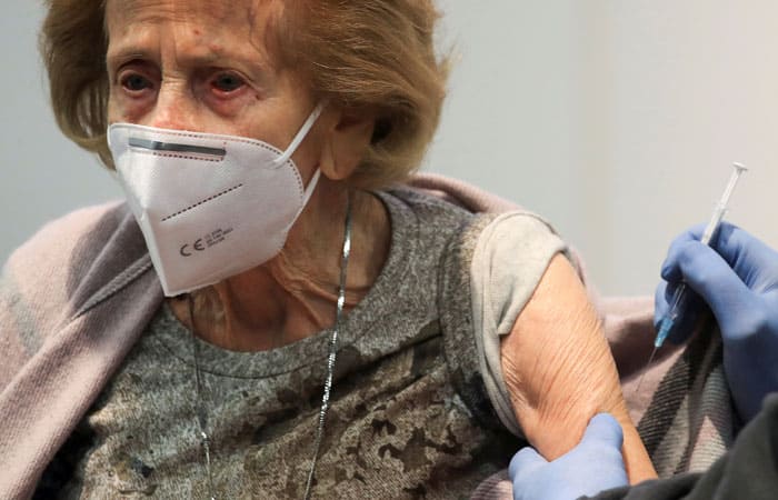 Elisabeth Steubsand, 105, receives a dose of the Pfizer-BioNTech COVID-19 vaccine, at a vaccination center temporarily set up in a fair hall in Cologne, Germany, Feb. 8, 2021. (CNS photo/Wolfgang Rattay, Reuters)