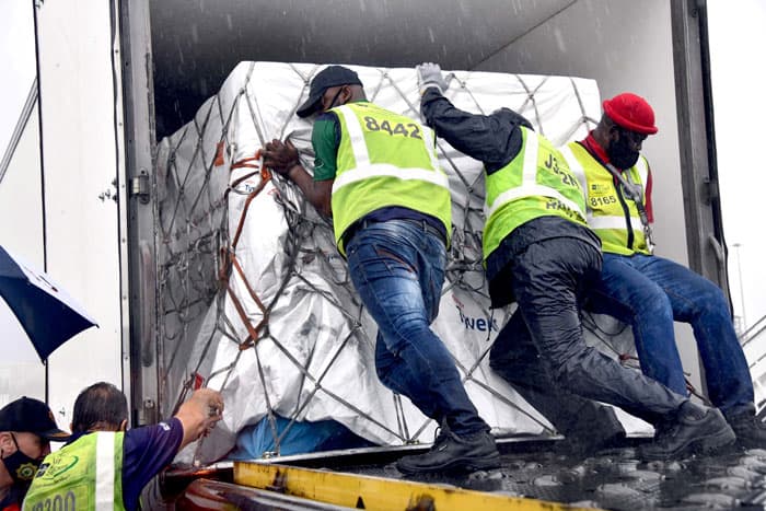 Workers load South Africa's first COVID-19 vaccine doses as they arrive at O.R. Tambo International Airport in Johannesburg Feb. 1, 2021. (CNS photo/Elmond Jiyane, GCIS handout via Reuters)