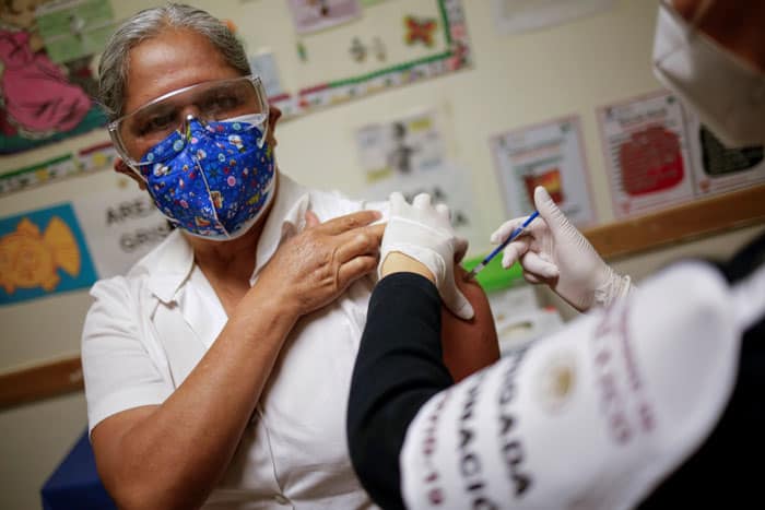 A health care worker receives an injection with a dose of the Pfizer-BioNTech COVID-19 vaccine at a hospital in Ciudad Juarez, Mexico, Jan. 14, 2021. (CNS photo/Jose Luis Gonzalez, Reuters)