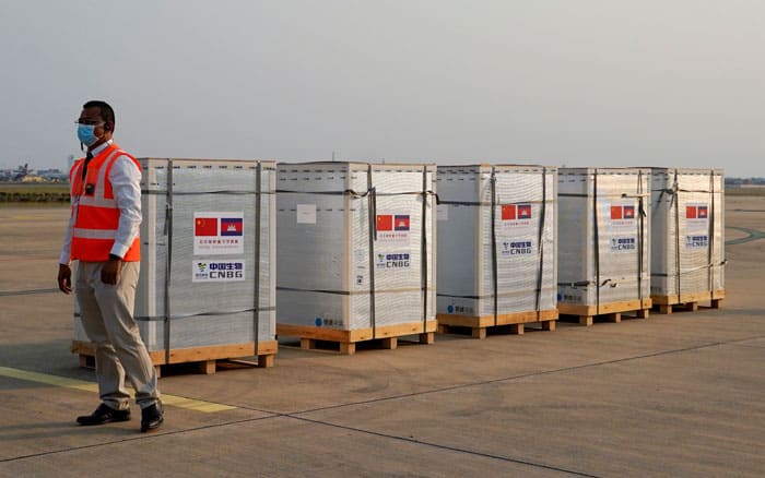 20210212T1015-VACCINES-ASIA-AUSTRALIA-1164803 Asia Ocenia roundup A worker stands next to the shipment of 600,000 doses of COVID-19 vaccines at Cambodia's Phnom Penh International Airport Feb. 7, 2021. The vaccines were donated by China. (CNS photo/Cindy Liu, Reuters)