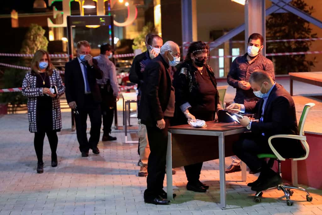 Christians arrive Feb. 15, 2021, to register their names at Catholic University in Irbil, Iraq, to attend the planned March 7 papal Mass at Franso Hariri Stadium. (CNS photo/Thaier al-Sudani, Reuters)