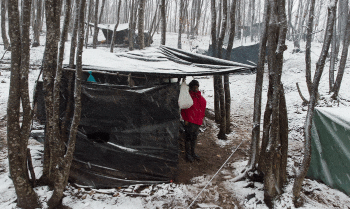 A migrant stands in his makeshift shelter during snowfall at a temporary camp near Velika Kladuša, Bosnia-Herzegovina, Jan. 31, 2021. Father Tomo Knezevic, head of Caritas in Bosnia-Herzegovina, has urged help for refugees stranded in drastic winter conditions in the Balkan country and accused the European Union of ignoring their plight and seeking to "wash its hands like Pilate." (CNS photo/Dado Ruvic, Reuters)
