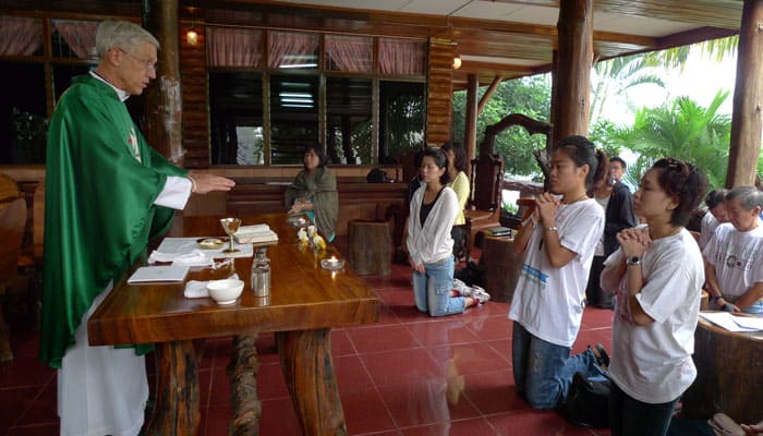 Maryknoll Father Lawrence Radice celebrates Mass with visitors from Singapore on a mission exposure trip to villages in northern Thailand. (Sean Sprague/Thailand)