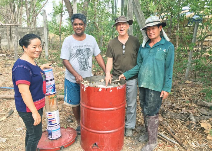Father-Radice-4 Staff members of RTRC (l. to r.) Ms. Phut, Mr. Sornchai, Father Radice and Mr. Manut make biochar by burning organic waste material. (Courtesy of Lawrence Radice/Thailand)