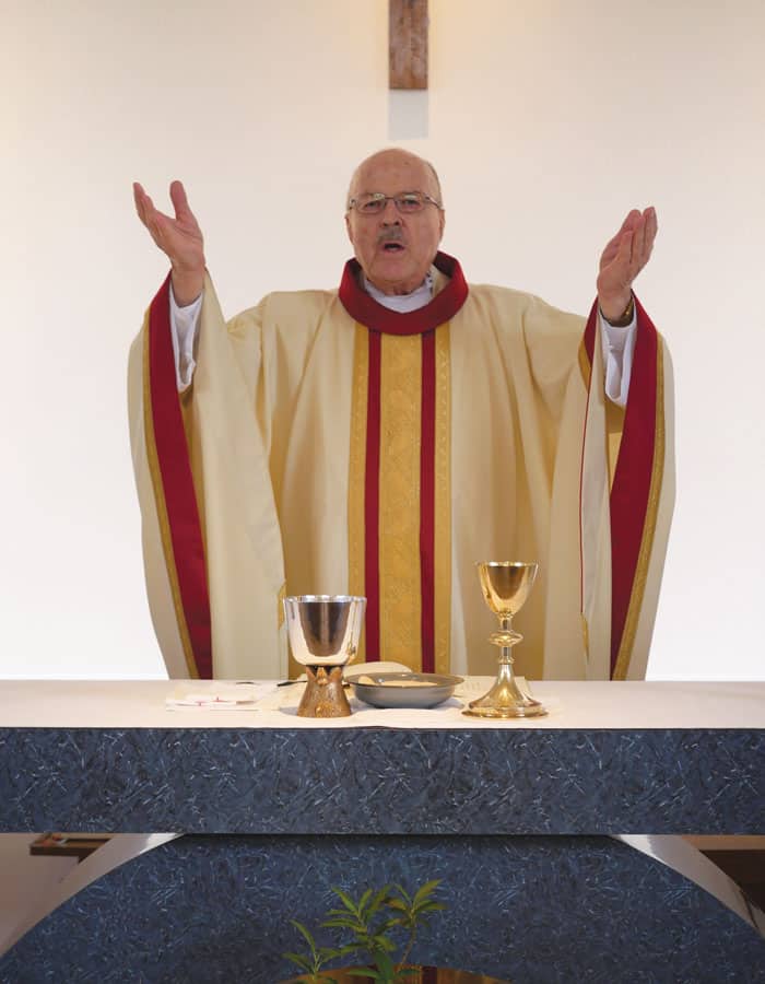 Father-Riha-1 At an unadorned altar in Higashi (East) Muroran parish Father Frank Riha celebrates Sunday liturgy with a “different aliveness” than in Africa and Latin America. (Peter Saunders/Japan)