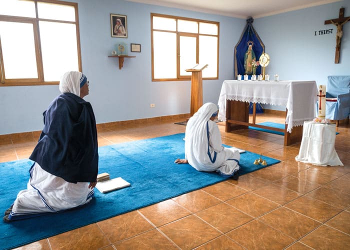 Sister Adelbert (left) and another Missionaries of Charity sister share a time of prayer and reflection in their small private chapel at the center where Lay Missioner John O’Donoghue serves. (Nile Sprague/Bolivia)