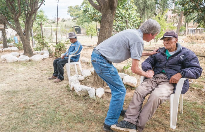 Lay-Missioner-2 O’Donoghue consoles Calixto Cejo, an elderly patient who has a hearing problem and is blind in one eye, at the center in Cochabamba, Bolivia. (Nile Sprague/Bolivia)