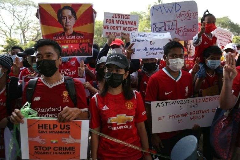 Myanmar Premier League football fans take part in a protest against the coup in Yangon on Feb. 12. (Photo: STR/AFP)