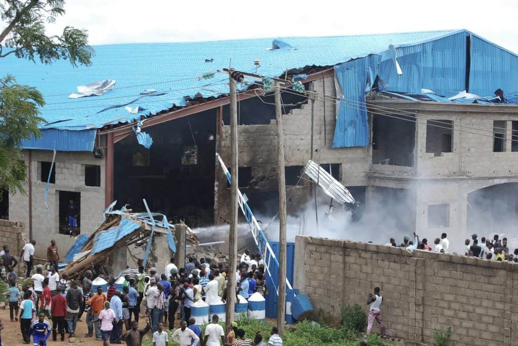 People gather near the damaged Shalom Church after deadly bombing in 2012 in the northern Nigerian city of Kaduna. (CNS photo/Stringer via Reuters) See EASTER-SEASON-ATTACKS April 22, 2019.