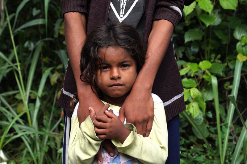 A Venezuelan migrant girl rests on the road leading to Pamplona, Colombia, in October 2020. The Biden administration announced March 8, 2021, it is offering 18-months of Temporary Protected Status to about 320,000 Venezuelans in the U.S. who fled their country's economic collapse. (CNS photo/Manuel Rueda)