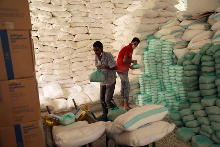 Workers prepare food at a distribution center supported by the World Food Program in Sanaa, Yemen, June 3, 2020. Parts of Yemen, South Sudan, Burkina Faso and Nigeria are close to or already facing famine. Other countries face severe food insecurity or worse. (CNS photo/Khaled Abdullah, Reuters)