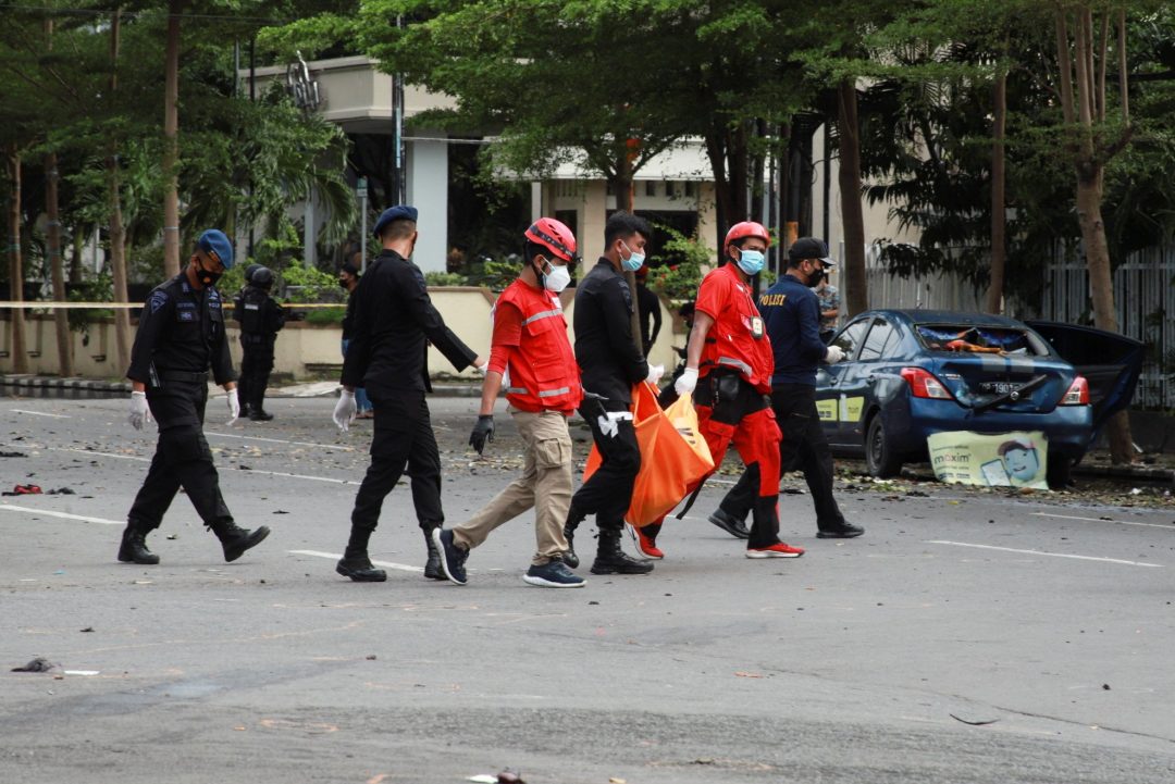 Indonesian Red Cross personnel carry a body bag following a suicide bomb attack during Palm Sunday Mass at Sacred Heart of Jesus Cathedral in Makassar, Indonesia, March 28, 2021. The two bombers died in the attack, and about 20 people were injured. (CNS photo/Reuters)