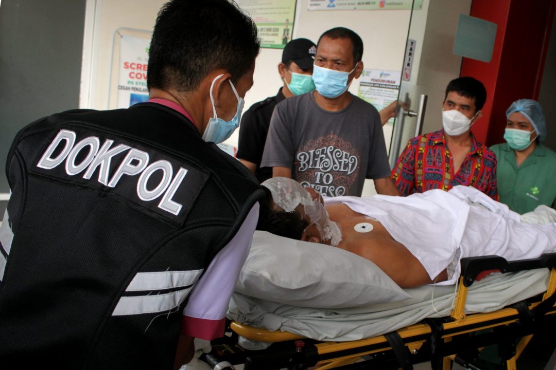 Police emergency personnel carry an injured man to an ambulance following a suicide bomb attack during Palm Sunday Mass at Sacred Heart of Jesus Cathedral in Makassar, Indonesia, March 28, 2021. (CNS photo/Arnas Padda, Antara Foto via Reuters)