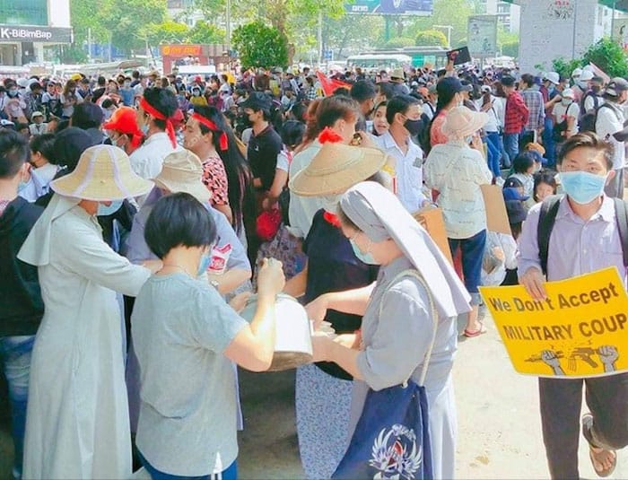 IMG-4504 Nuns from the Sisters of St. Joseph of the Apparition congregation offer drinks and food to young protesters in Yangon on Feb. 25. (Photo: SJA via UCA News/Myanmar)