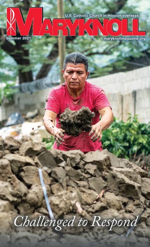Hunter Lopez unloads mud from his mother’s flooded home in Chamelecón, Honduras. (Gregg Brekke/Honduras)