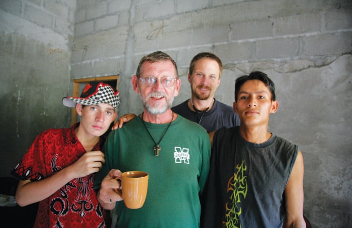 Father Thomas Goekler pauses for a coffee break with two local youths and a visiting doctor, Brandon Stark of Chico, California, in a 2006 photo in Chamelecón.(Sean Sprague/Honduras)