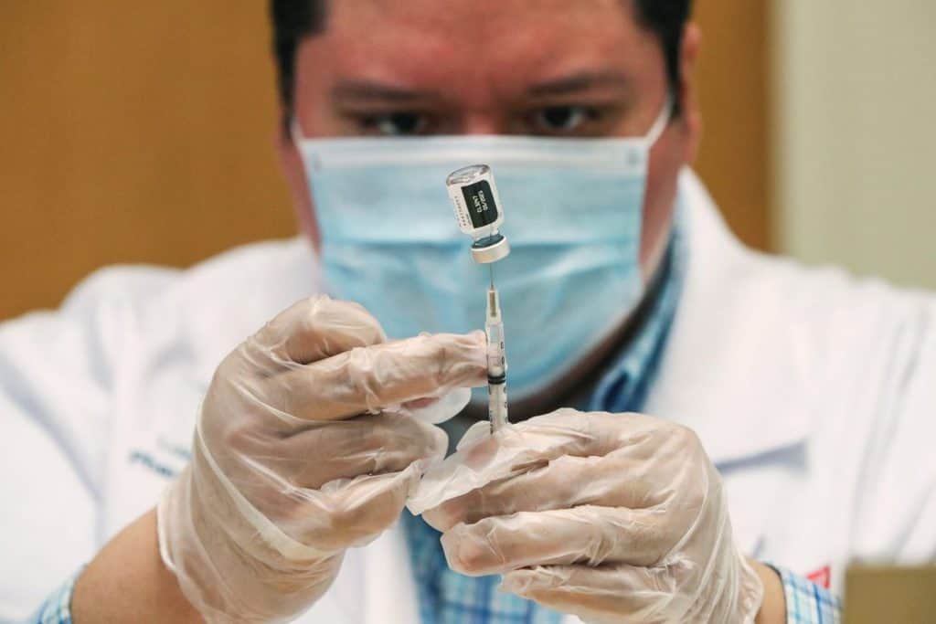 A Walgreens health care professional prepares a dose of the Pfizer-BioNTec COVID-19 vaccine in Evanston, Ill., Feb. 22, 2021. A new Catholic coalition says vaccines need to be accessible to all.(CNS photo/Kamil Krzaczynski, Reuters)